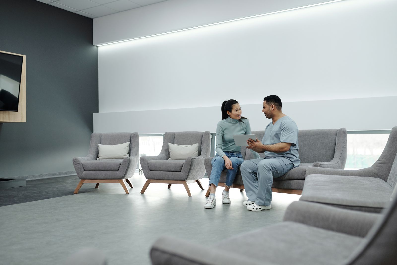 Doctor talking with a patient in a clinic waiting room